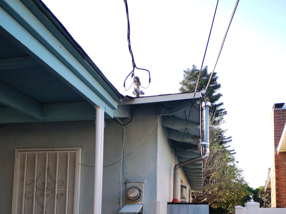 Original meter and subpanel with overhead service drop before panel upgrade in Winnetka - AMY Electric